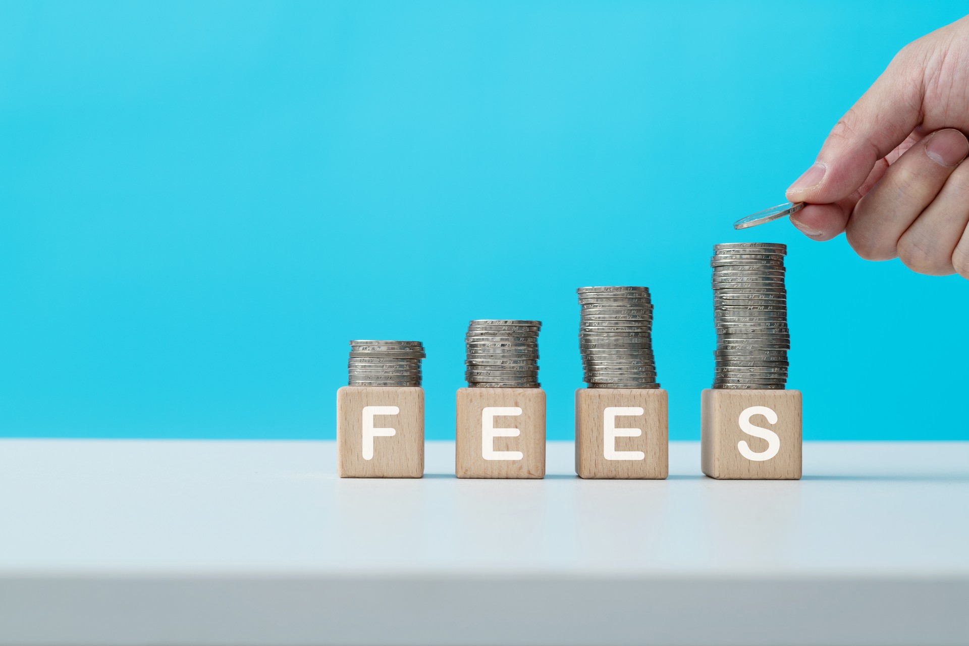 Stack of coins on word fees