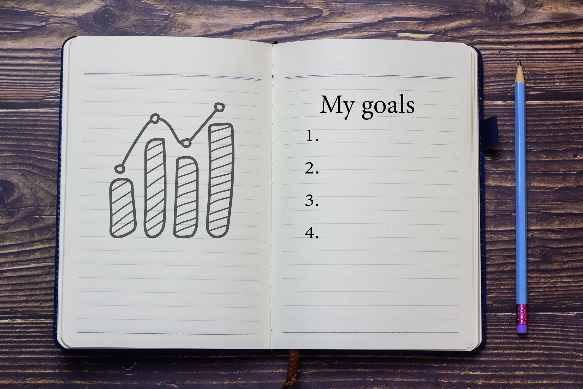 My goals text notebook and pencil placed on the table