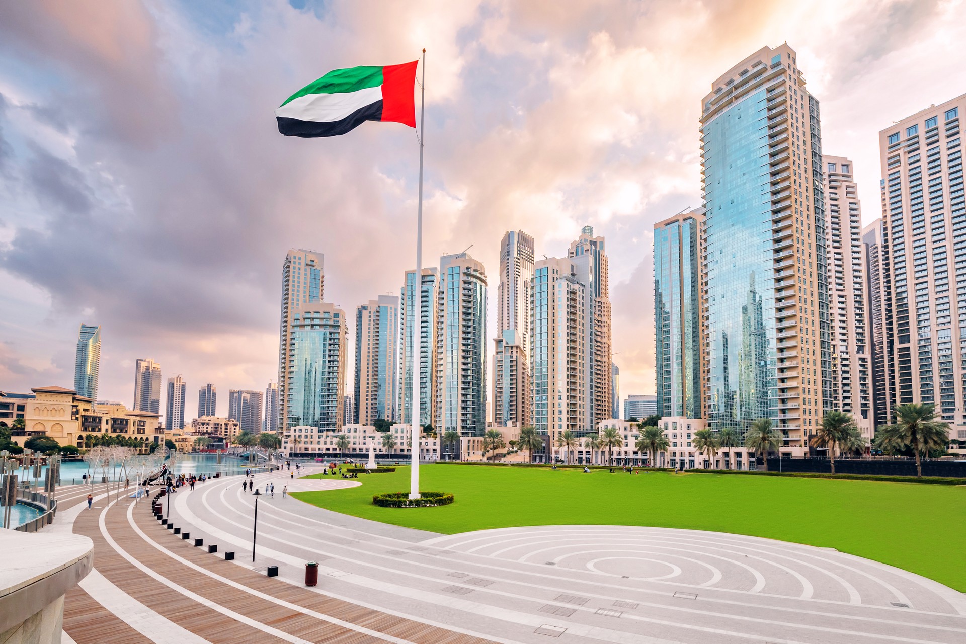 Scenic view of Dubai skyline, with the skyscraper buildings and national flag. Sightseeing and travel destinations in Arab Emirates